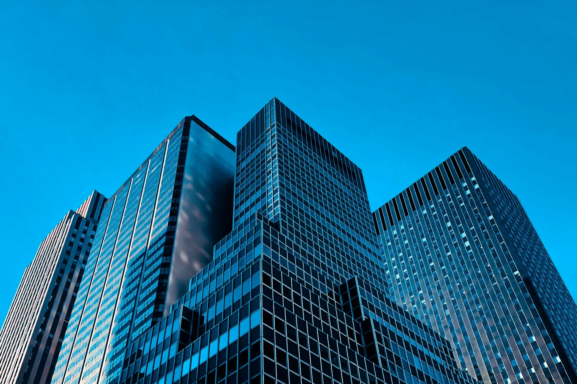 Blue glass office towers in sunlight