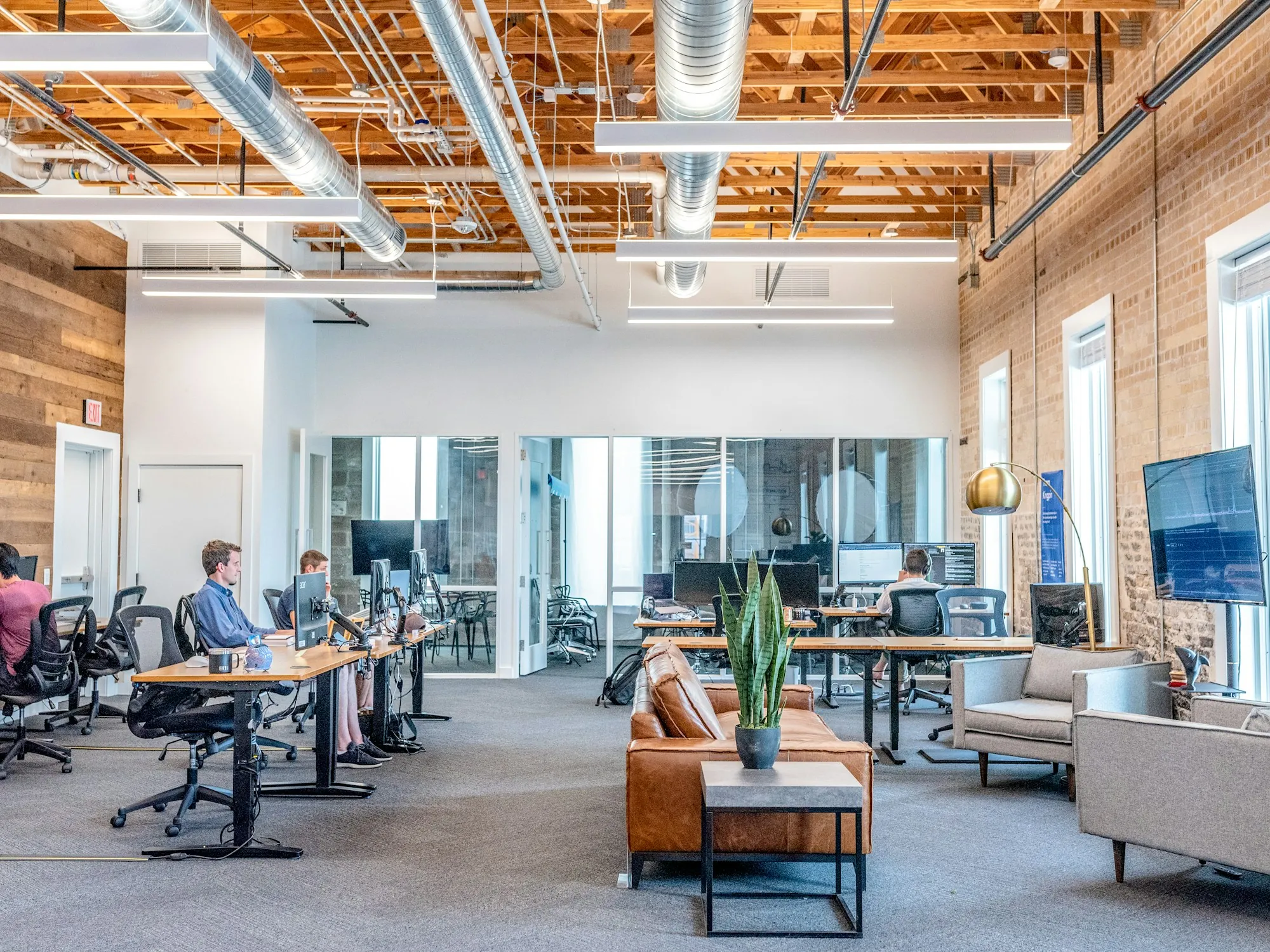 Busy open office with brick walls and natural light