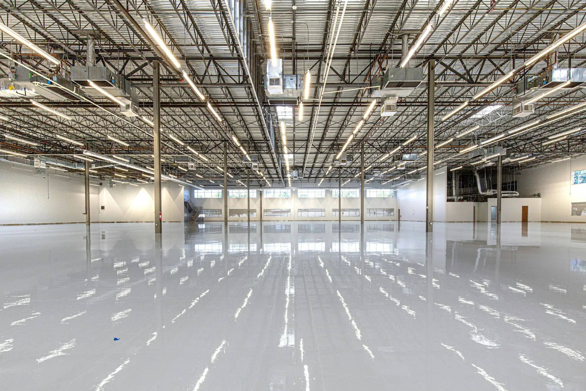 Wide warehouse interior with polished concrete and skylights